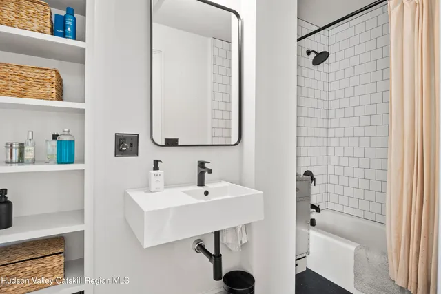 a bathroom with a sink a mirror and shower