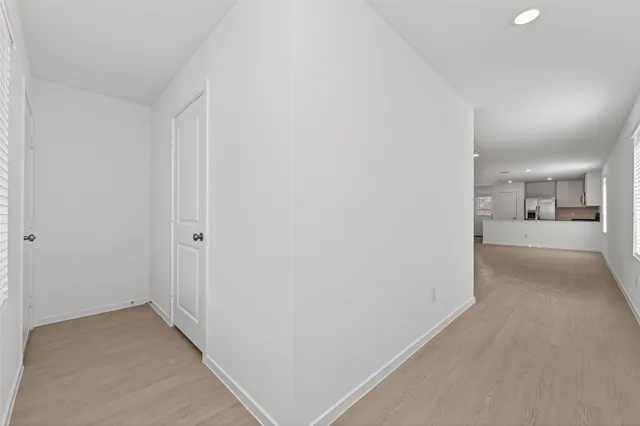 a view of a hallway with wooden floor