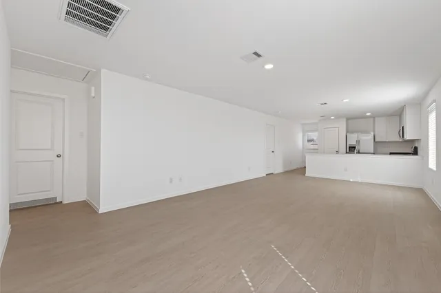 a view of kitchen and refrigerator