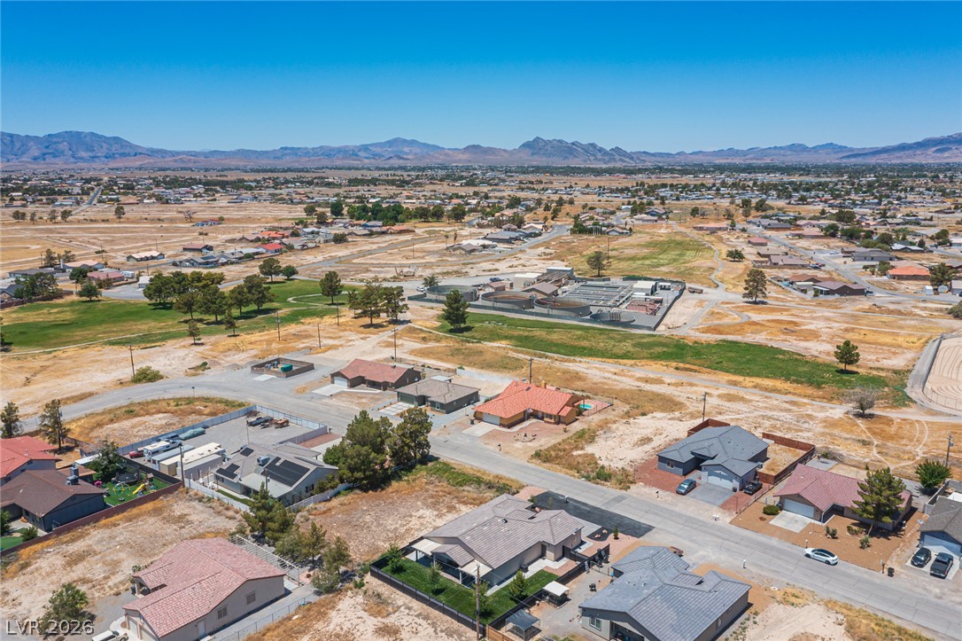441 Belville Road Pahrump, NV 89048 - Photo 43 of 44 An aerial perspective reveals a vast suburban landscape with houses nestled against a backdrop of distant mountains.