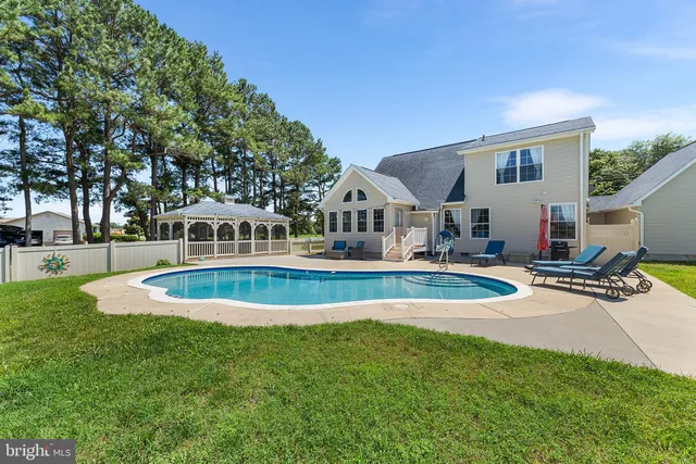a view of a house with swimming pool and sitting area