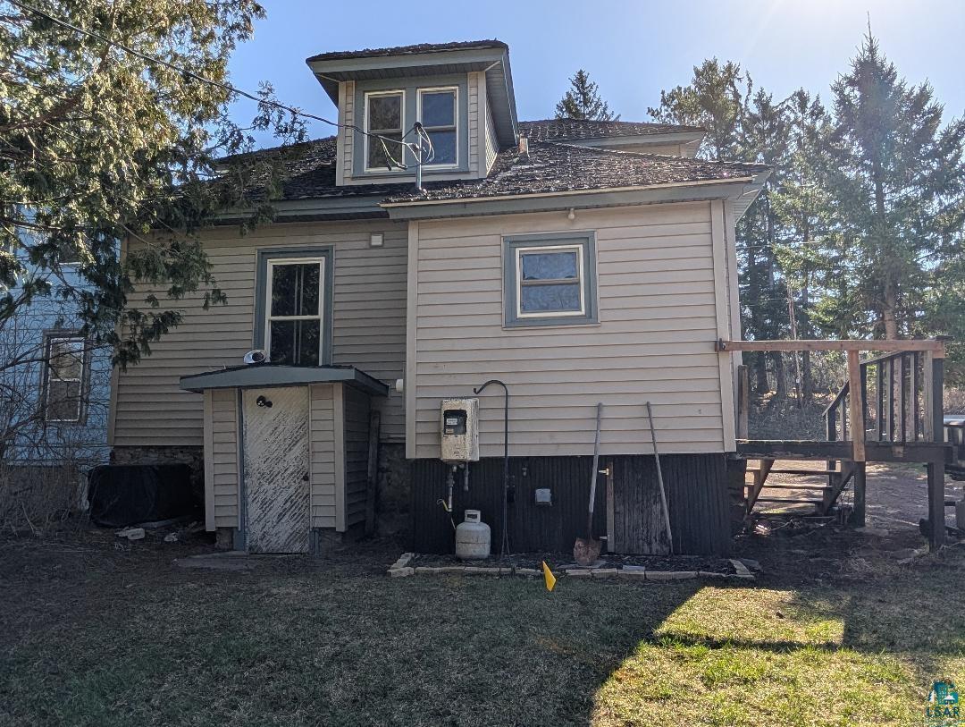 513 South Main Street Mellen, WI 54546 - Photo 5 of 22 Multi-level siding exterior with dormer window, lower-level door, and an exterior deck featuring wood railing