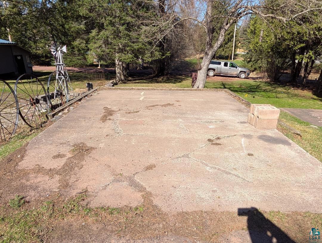 513 South Main Street Mellen, WI 54546 - Photo 7 of 22 Paved concrete surface with surrounding green spaces and mature trees