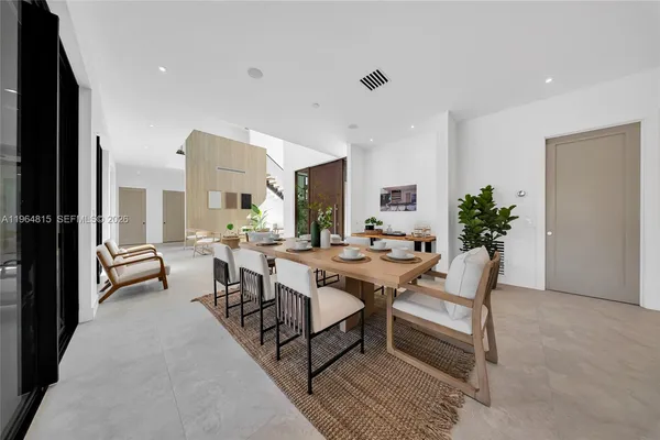 a living room with furniture and a floor to ceiling window