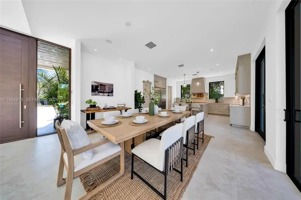 a large kitchen with a table and chairs