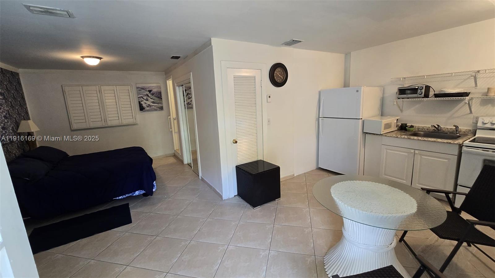 1901 Southwest 2nd Avenue, Unit 1 Miami, FL 33129 - Photo 1 of 13 a living room with furniture and a chair