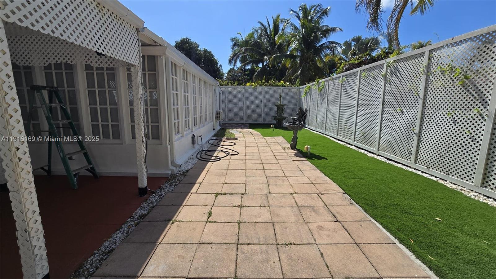 1901 Southwest 2nd Avenue, Unit 1 Miami, FL 33129 - Photo 12 of 13 a view of a pathway with a wrought fence