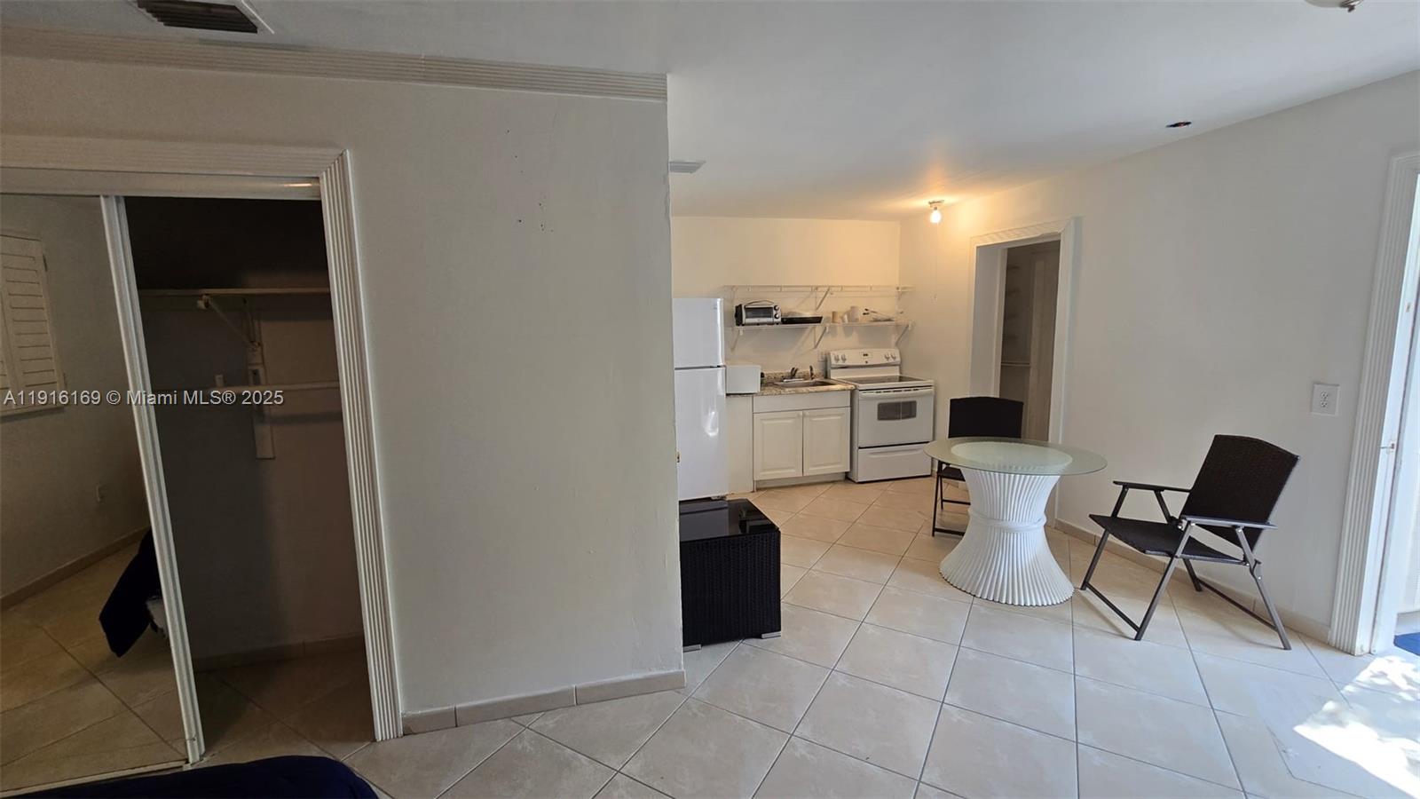 1901 Southwest 2nd Avenue, Unit 1 Miami, FL 33129 - Photo 4 of 13 a view of a kitchen with chair and refrigerator