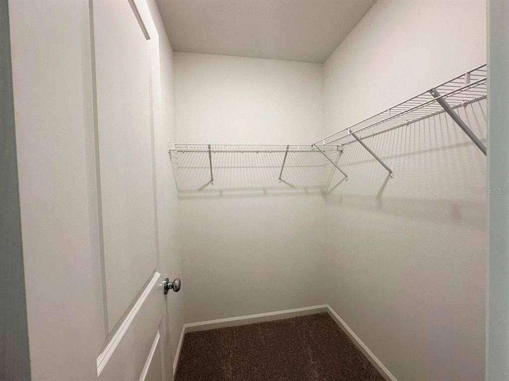 339 Puma Loop Groveland, FL 34736 - Photo 15 of 23 a view of a room with racks on the wall