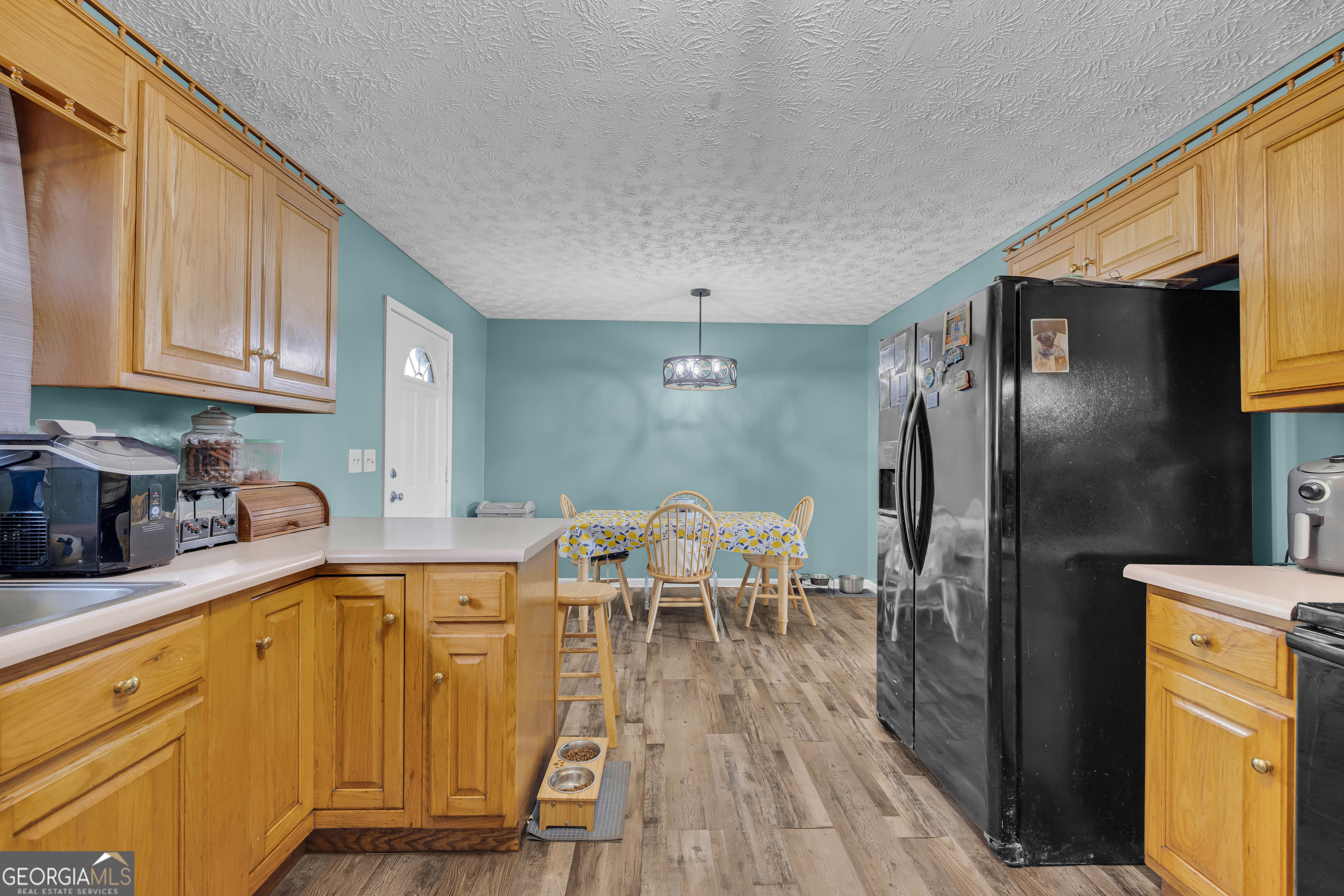 156 Shirley Road Royston, GA 30662 - Photo 11 of 29 a kitchen with stainless steel appliances granite countertop a refrigerator a sink dishwasher a stove and white cabinets with wooden floor
