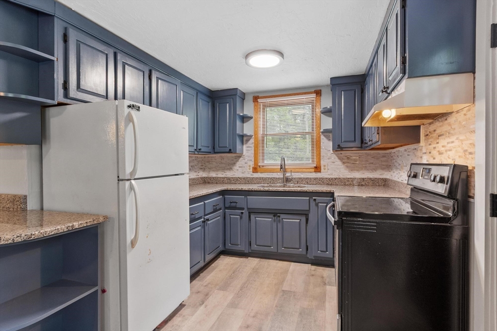 258 Allen Road Ashby, MA 01431 - Photo 8 of 36 a kitchen with granite countertop a refrigerator stove top oven and sink