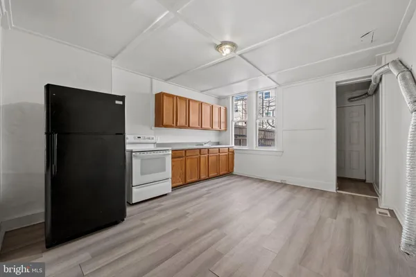 a kitchen with granite countertop a refrigerator and a sink
