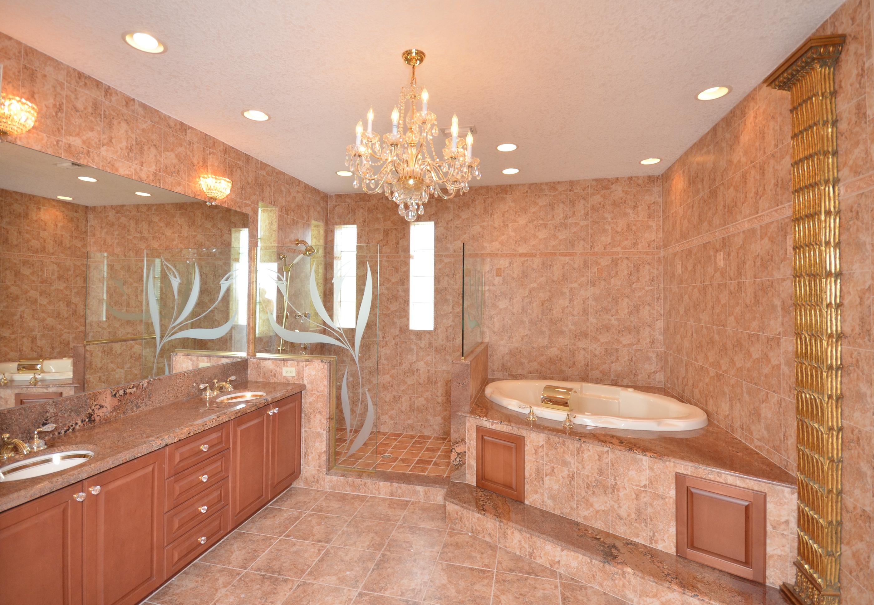 10873 Ravel Court Boca Raton, FL 33498 - Photo 11 of 18 a spacious bathroom with a double vanity sink toilet mirror and bathtub
