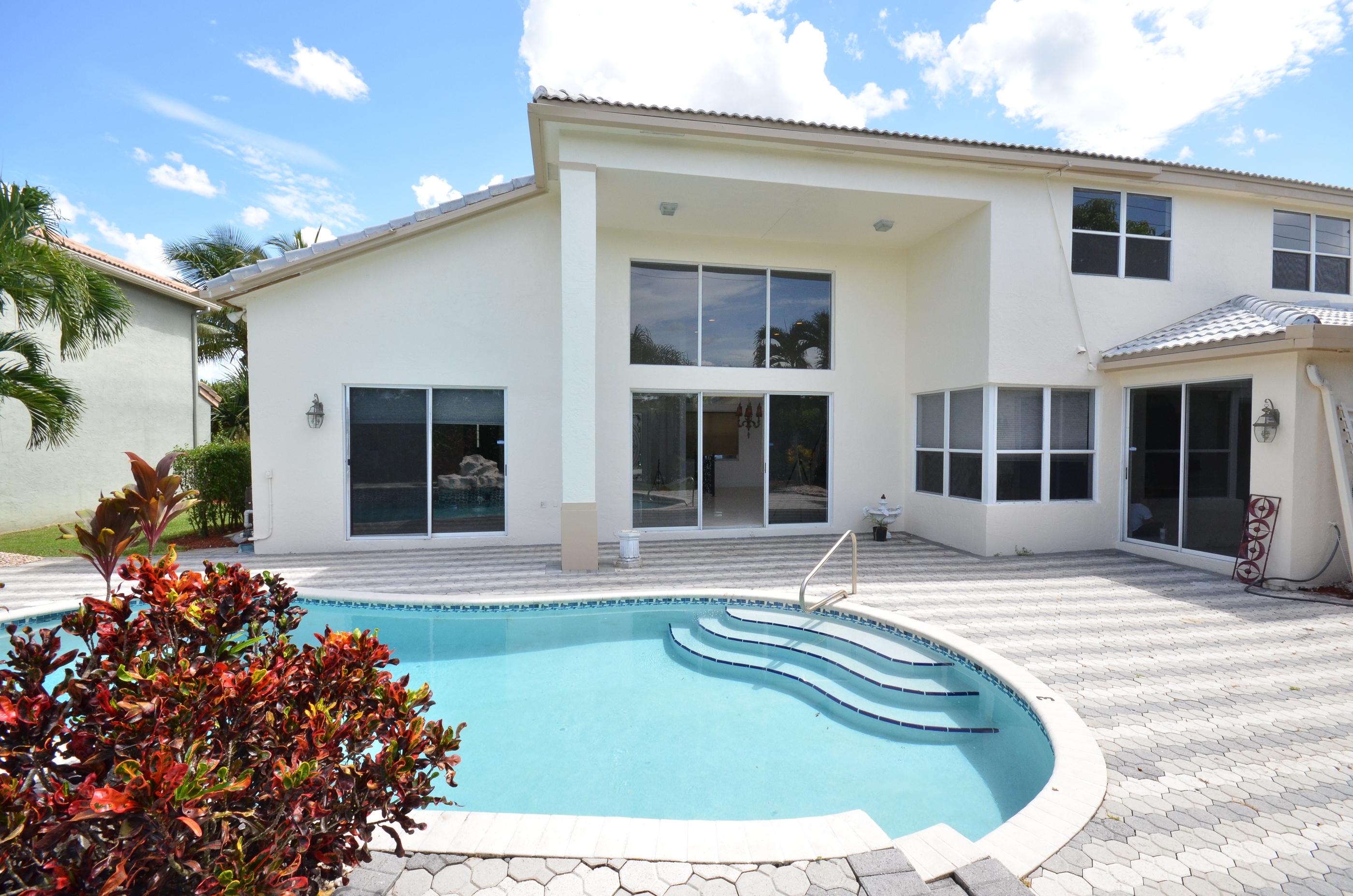 10873 Ravel Court Boca Raton, FL 33498 - Photo 18 of 18 a view of a house with sitting area and garden