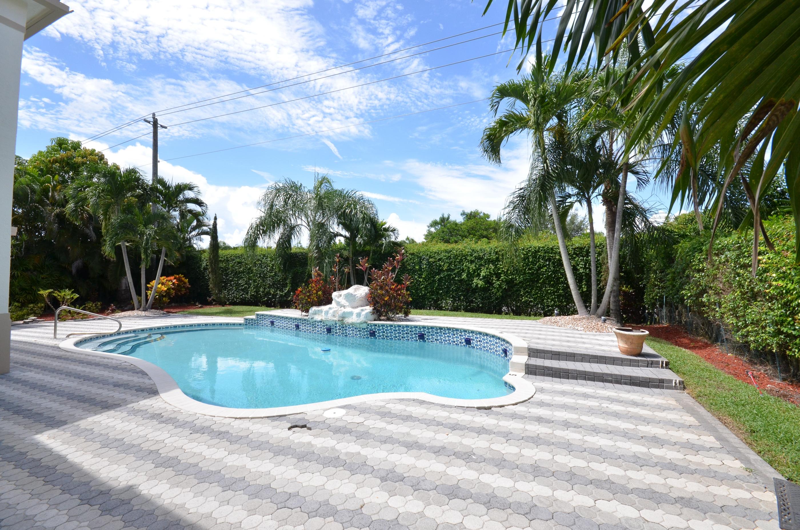 10873 Ravel Court Boca Raton, FL 33498 - Photo 4 of 18 a view of a swimming pool with a yard