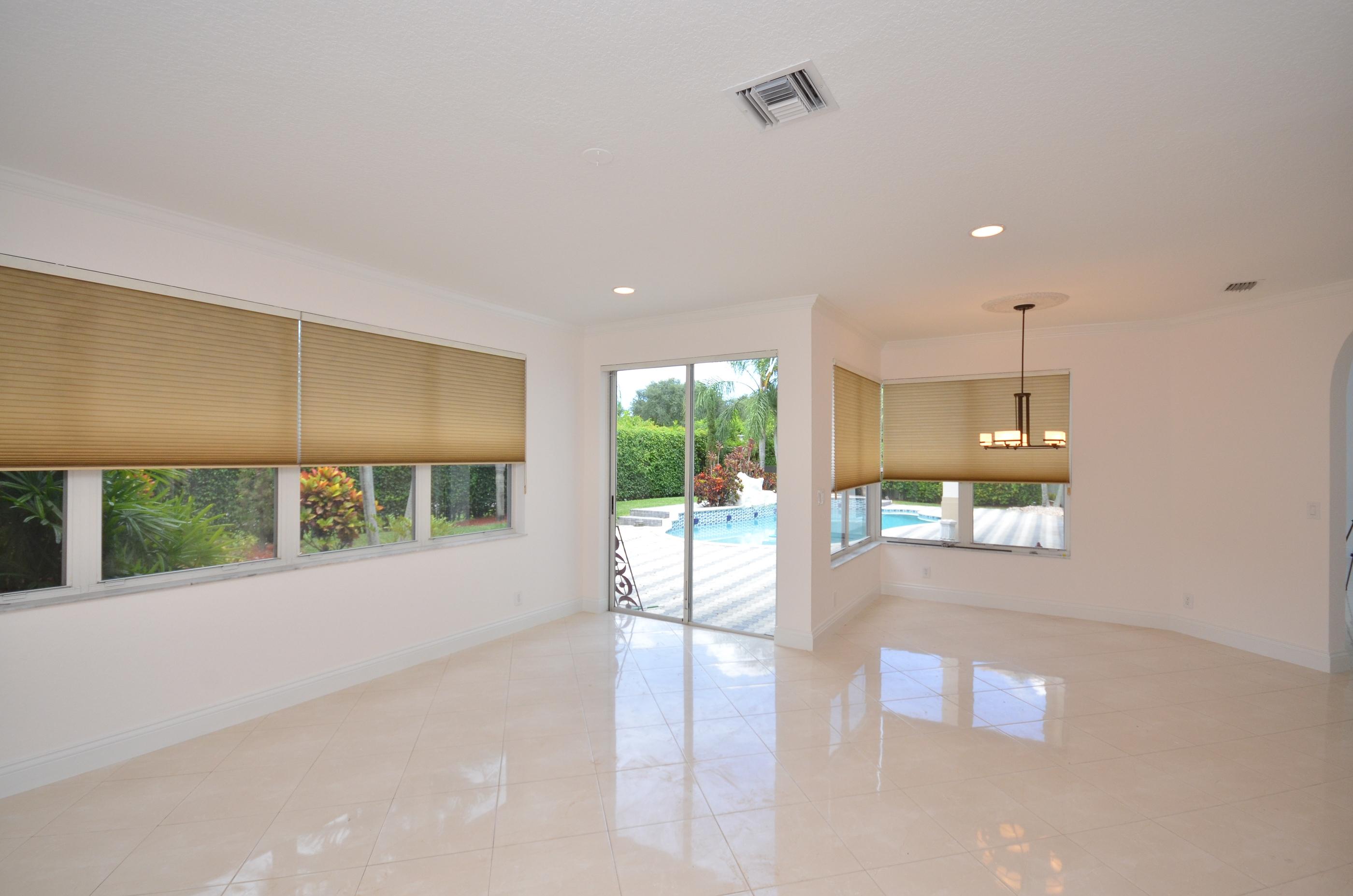 10873 Ravel Court Boca Raton, FL 33498 - Photo 10 of 18 a open kitchen with stainless steel appliances a large window in it