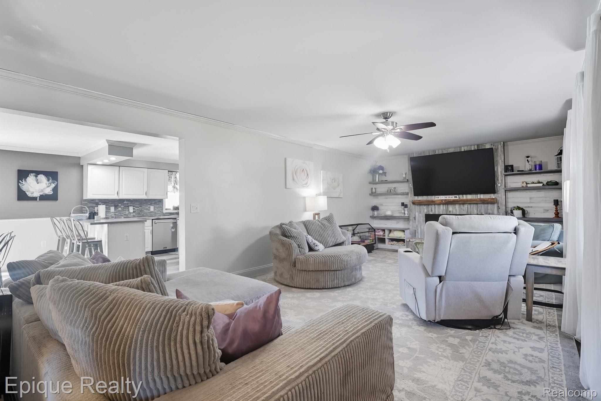 13265 Tibbets Road Memphis, MI 48041 - Photo 19 of 48 Living room featuring ornamental molding and a ceiling fan
