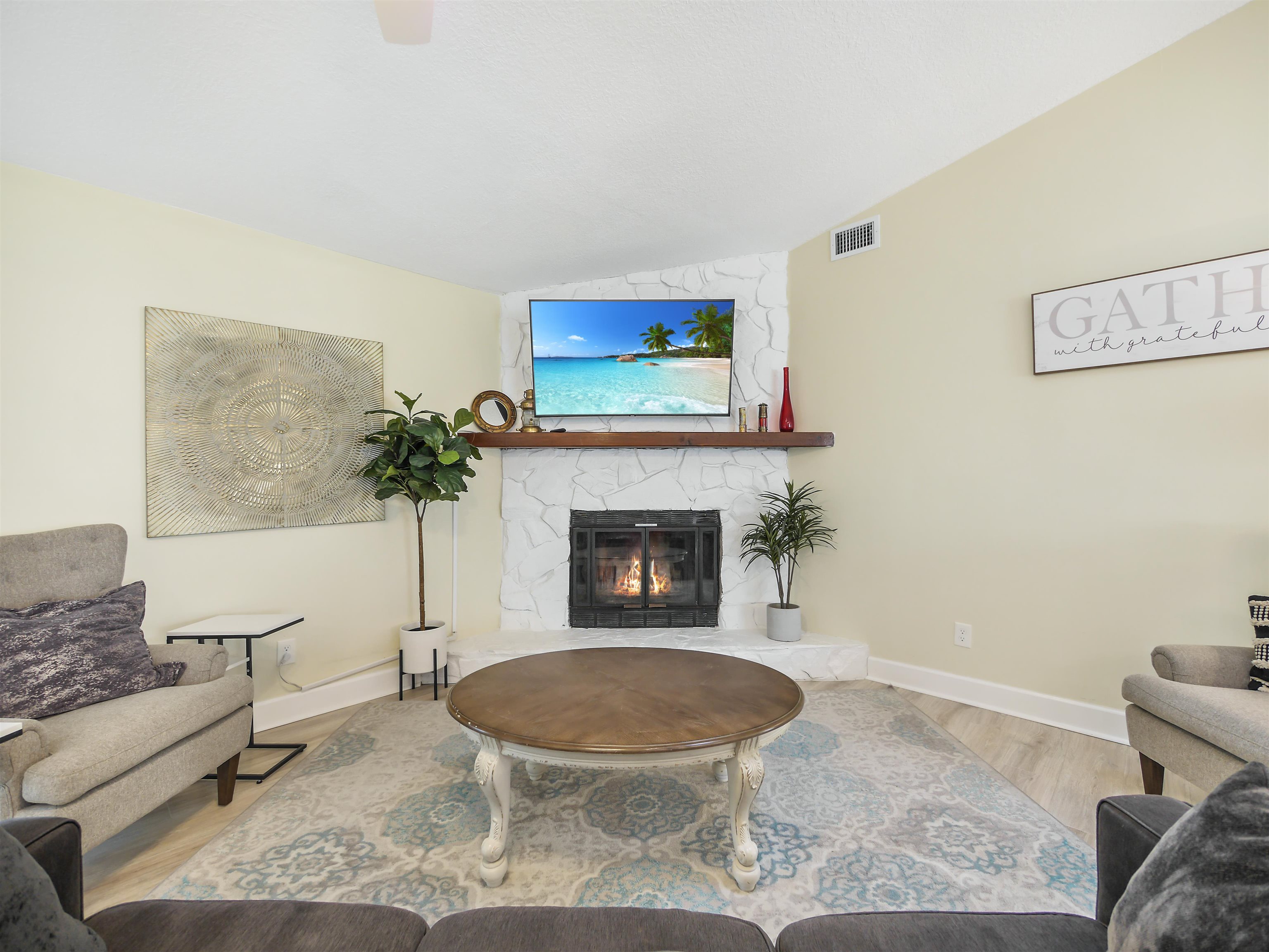 140 Hawthorne Road St. Augustine, FL 32086 - Photo 12 of 39 a living room with furniture a flat screen tv and a fireplace