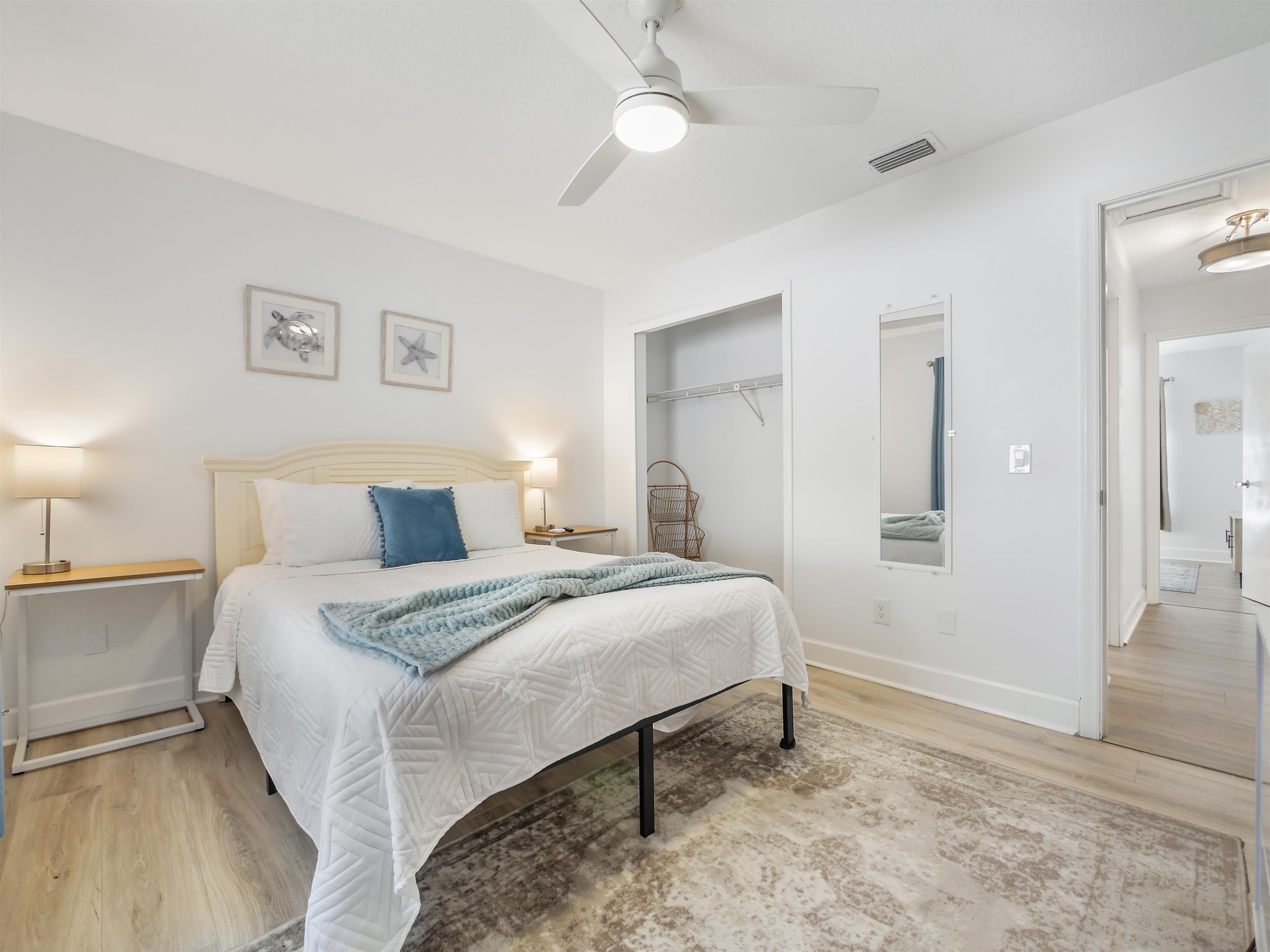 140 Hawthorne Road St. Augustine, FL 32086 - Photo 24 of 39 a spacious bedroom with a bed and a chandelier