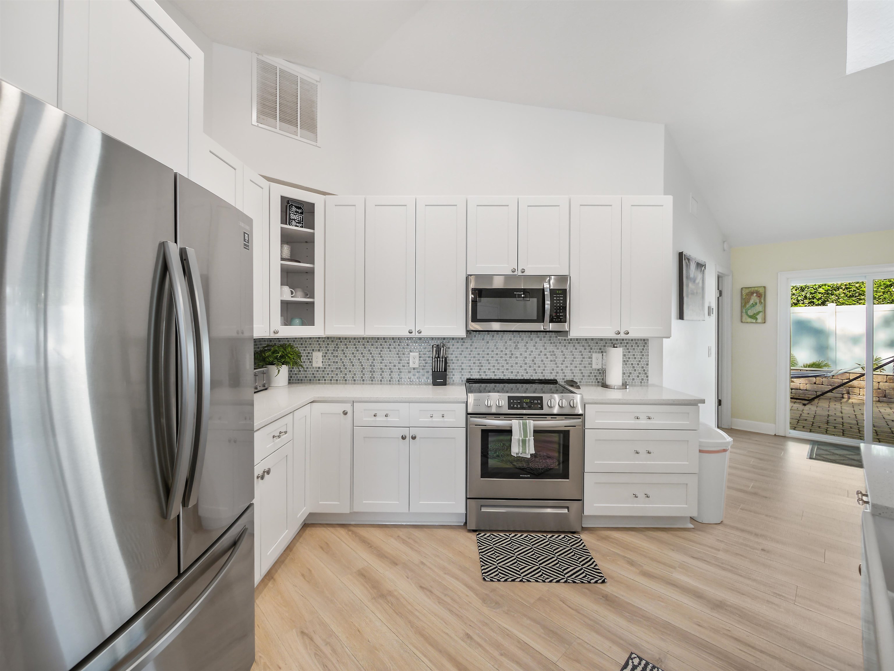 140 Hawthorne Road St. Augustine, FL 32086 - Photo 4 of 39 a kitchen with white cabinets stainless steel appliances and sink
