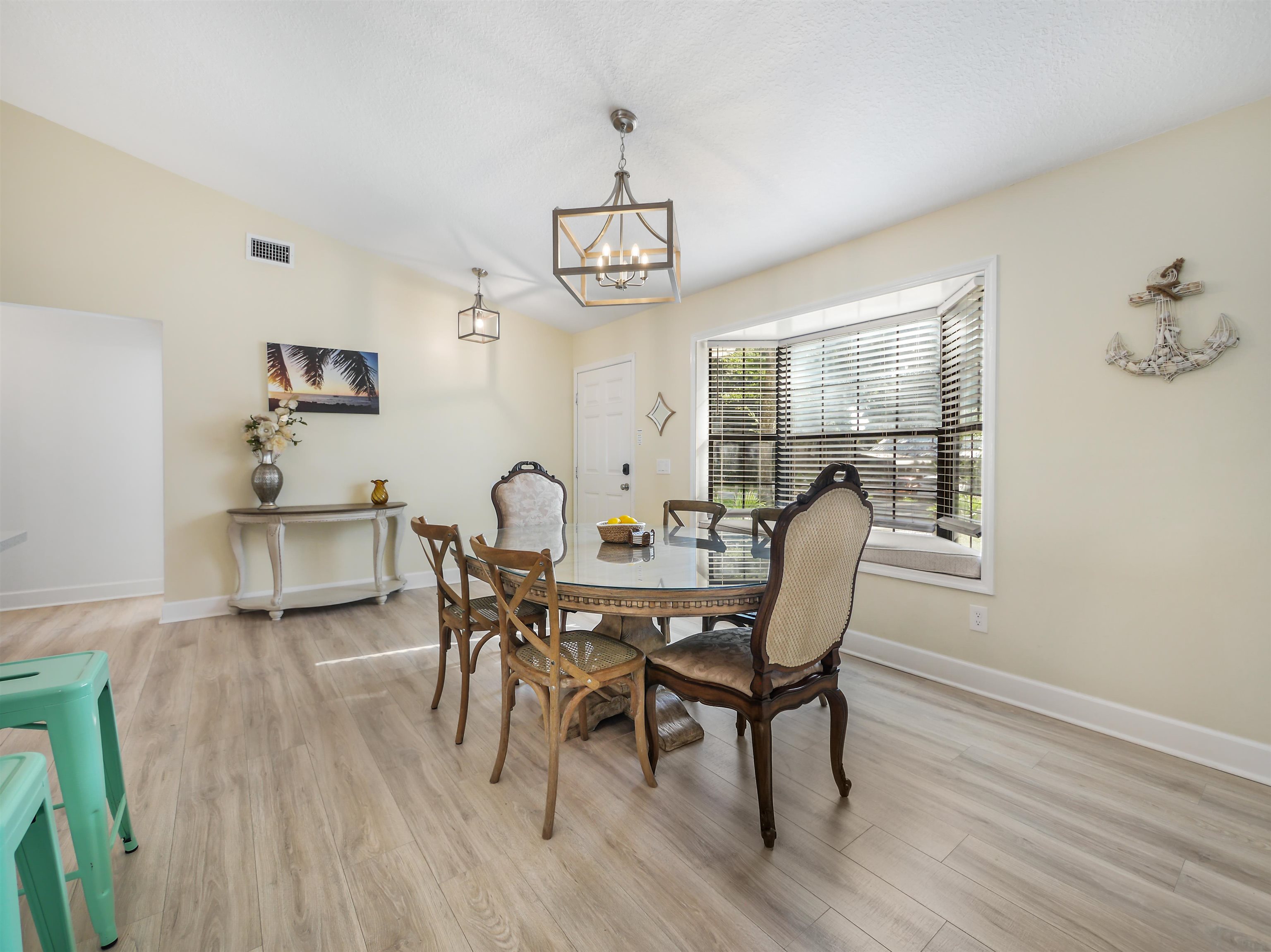 140 Hawthorne Road St. Augustine, FL 32086 - Photo 9 of 39 a view of a dining room with furniture and wooden floor