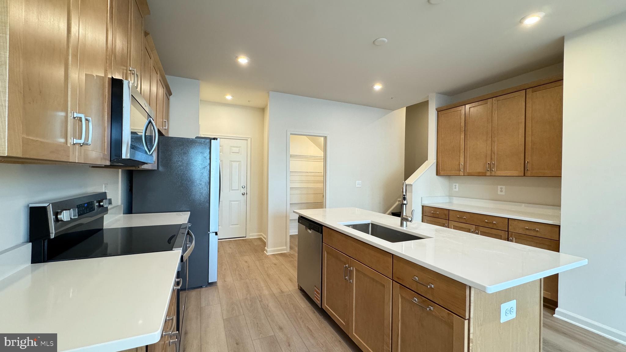 2613 River Birch Road Herndon, VA 20171 - Photo 4 of 14 a kitchen that has a sink stainless steel appliances a counter space and cabinets