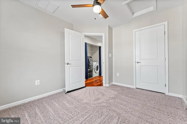 a view of an empty room with a ceiling fan