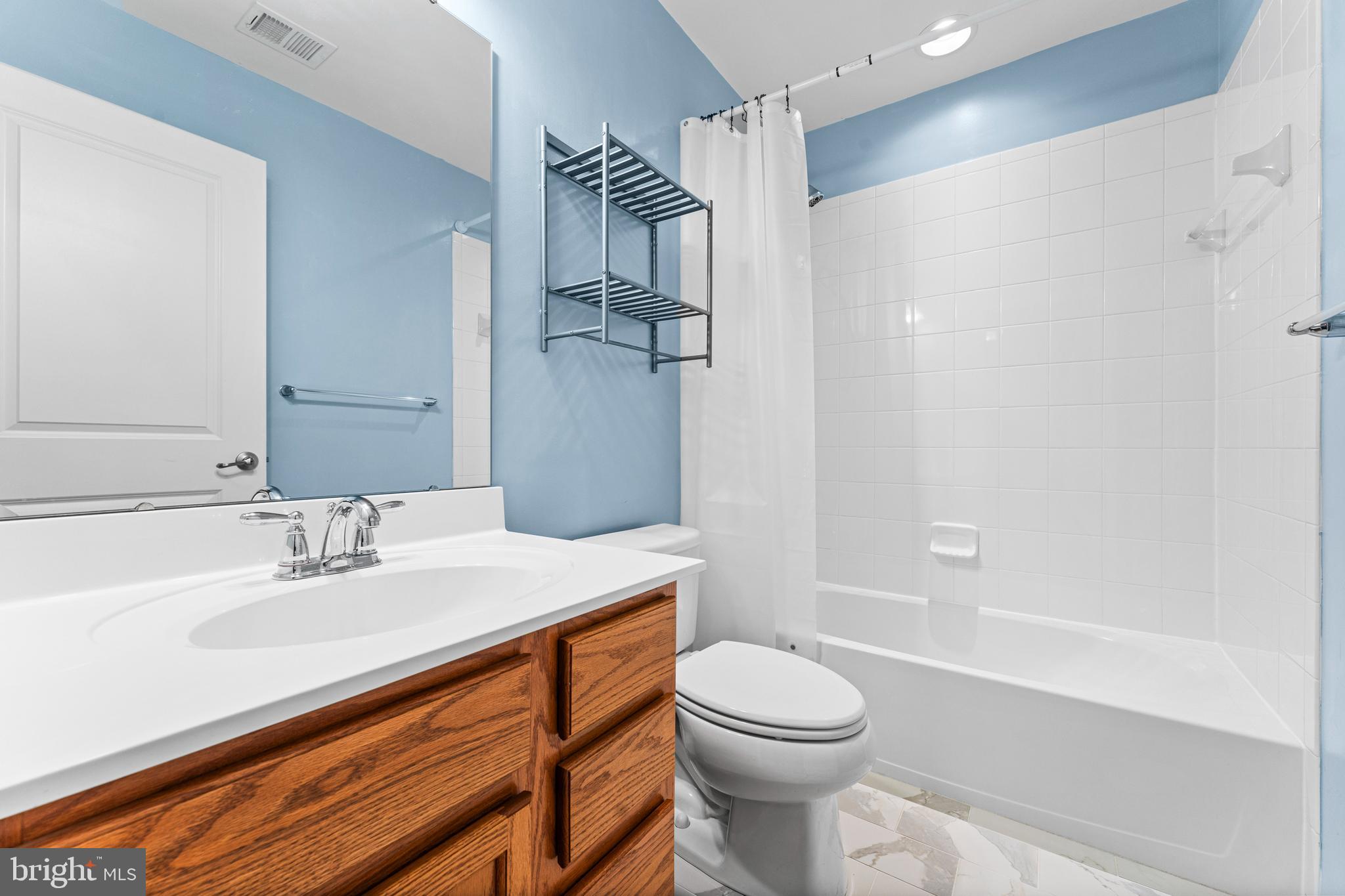 104 Spring Park Lane, Unit 43 Fredericksburg, VA 22405 - Photo 17 of 36 a bathroom with a sink a toilet and shower