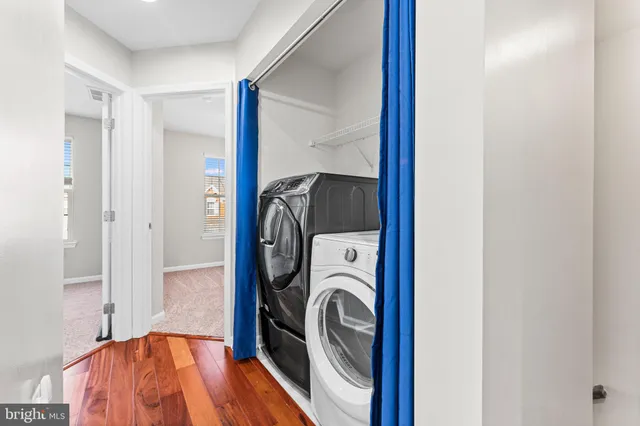 a view of a bedroom with washer and dryer