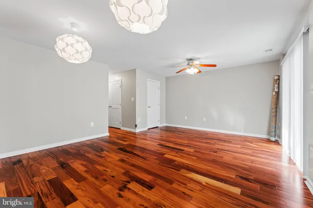 a view of a room with wooden floor and a window