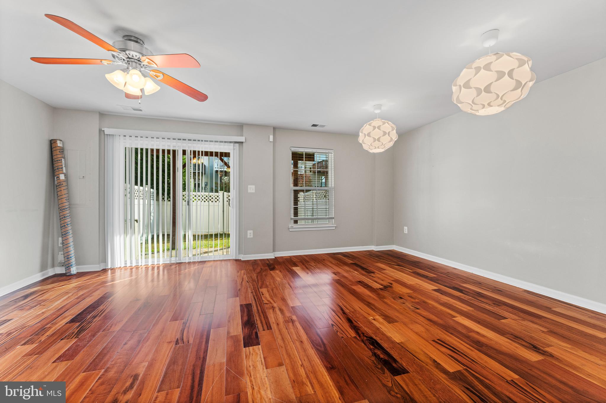 104 Spring Park Lane, Unit 43 Fredericksburg, VA 22405 - Photo 22 of 36 a view of an empty room with wooden floor and a window