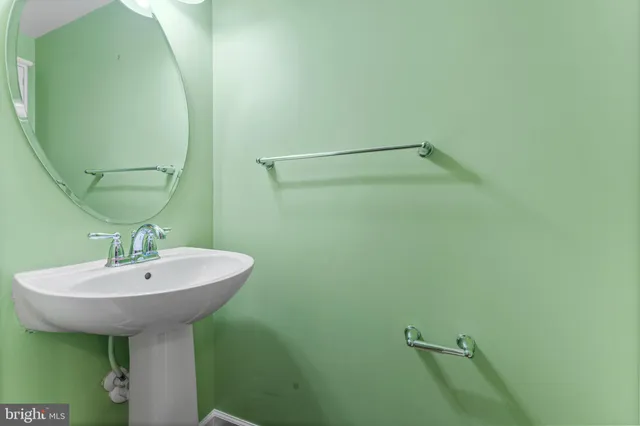 a bathroom with a sink and mirror
