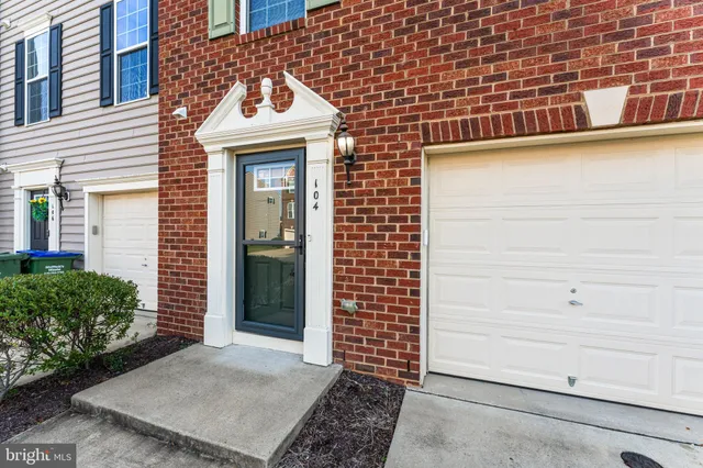 a view of a brick house with a door and wooden floor