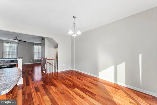 a workspace with wooden floor and chandelier