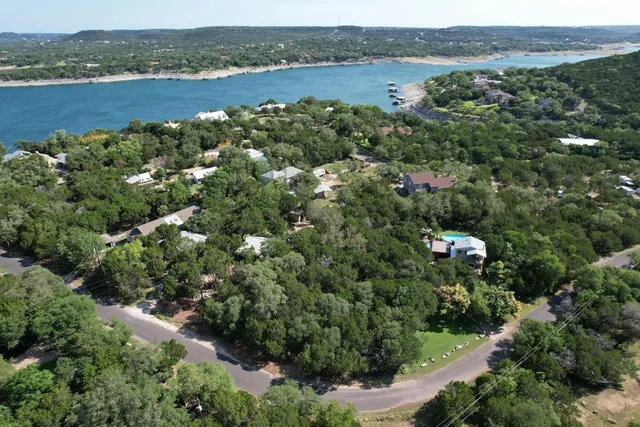 an aerial view of a houses with outdoor space and lake view