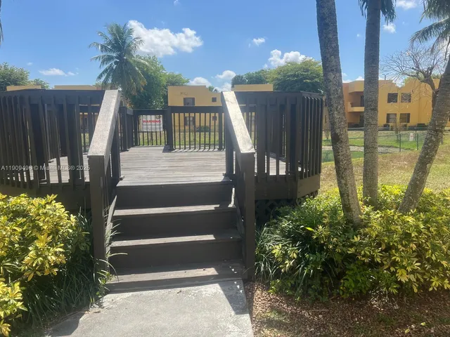 a view of residential houses with outdoor space and lake view