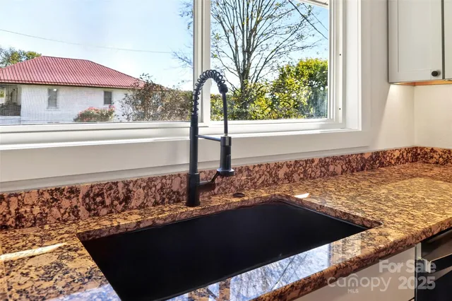 a view of a floor to ceiling window and a wooden fence