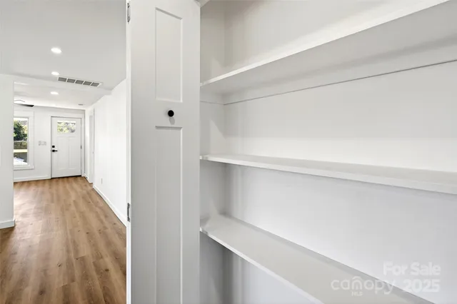 a view of hallway with wooden floor
