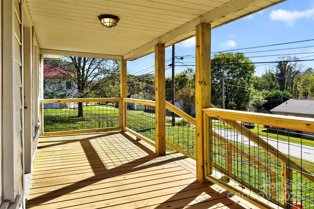 a view of a balcony with wooden floor