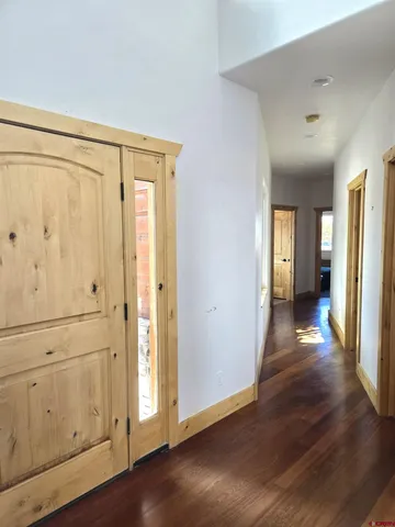 a view of a hallway with wooden floor
