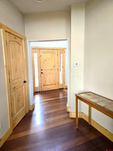 a view of empty room with wooden floor