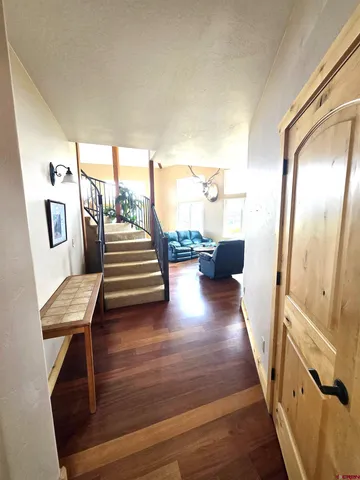 a view of entryway and hall with wooden floor