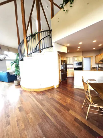 a view of a living room and kitchen with furniture and a floor to ceiling window