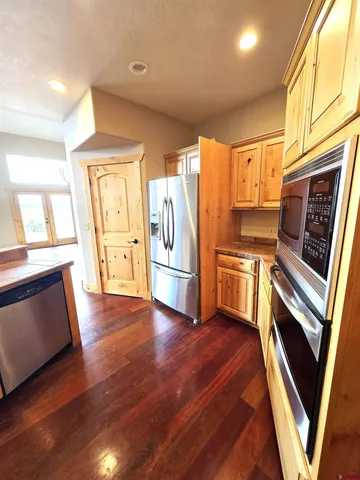 a kitchen with granite countertop stainless steel appliances and counter space