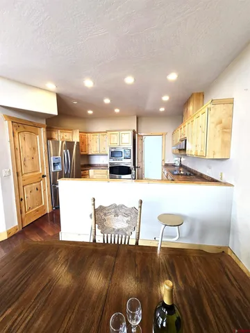 a view of kitchen with furniture and appliances