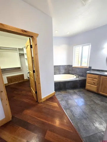 a bathroom with a tub and a sink