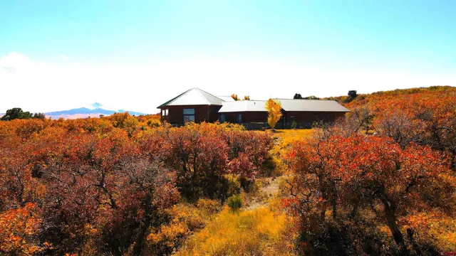 an aerial view of a house with mountain view