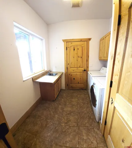 a spacious bathroom with a sink a bathtub and a window