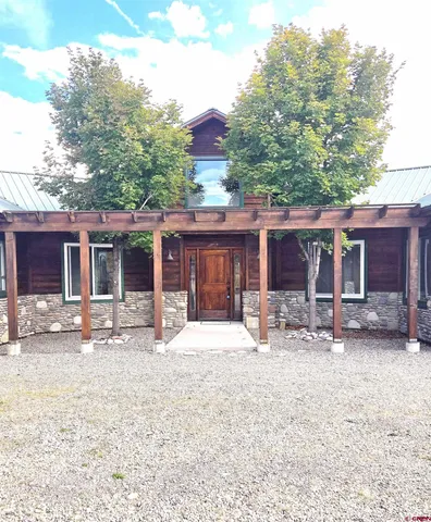 a front view of a house with a yard and parking space