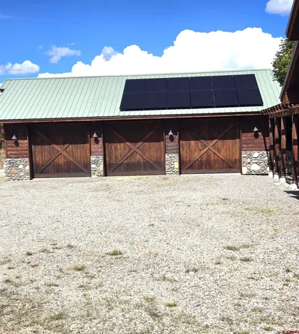 a view of house with yard and garage